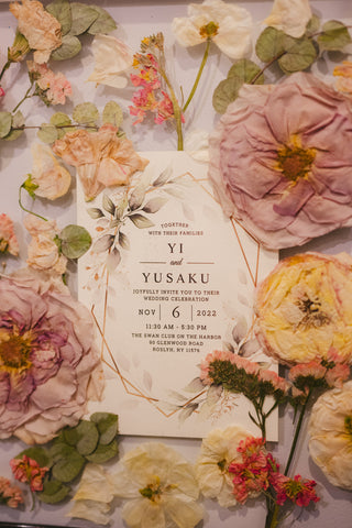 a white card with pink flowers around it